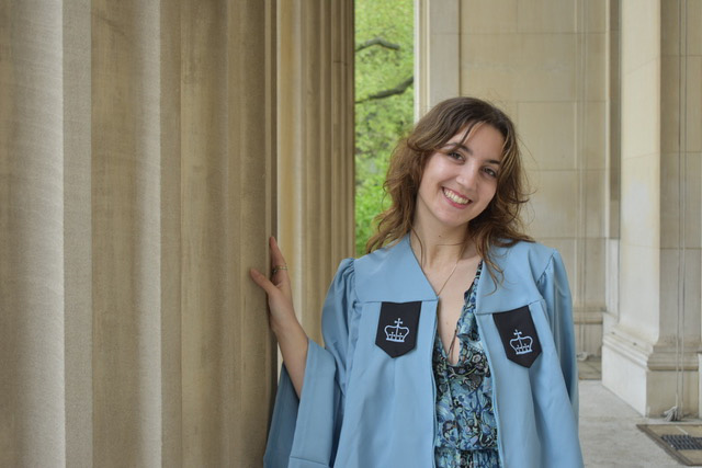 Young woman in blue graduation regalia
